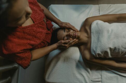 A woman enjoying a relaxing massage therapy session at a spa, promoting wellness and relaxation.