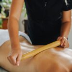 Experience ultimate relaxation with a rejuvenating bamboo massage in a tranquil spa setting.