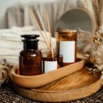 A tranquil spa setup featuring aromatherapy oils, candles, and dried flowers for relaxation.