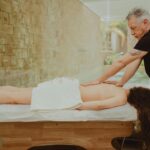 Professional massage therapist performing a relaxing spa treatment in a serene setting.