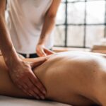 Experience relaxation with a full body massage in a serene indoor spa environment.